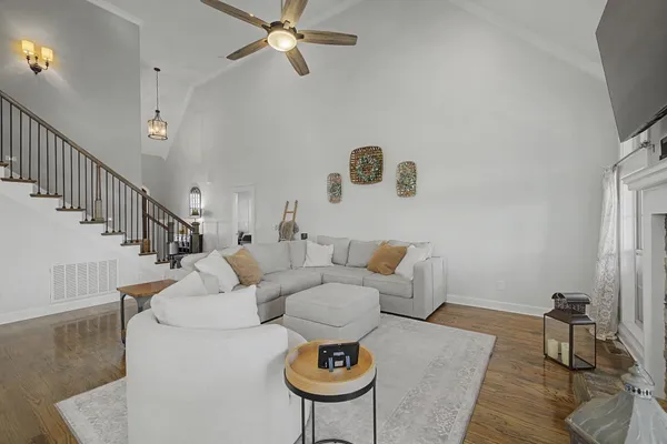 a living room with furniture and a clock