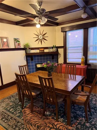 a view of a dining room with furniture and wooden floor