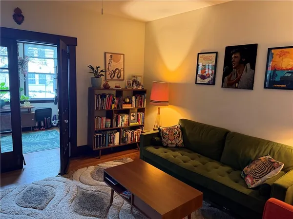 a living room with furniture and wooden floor