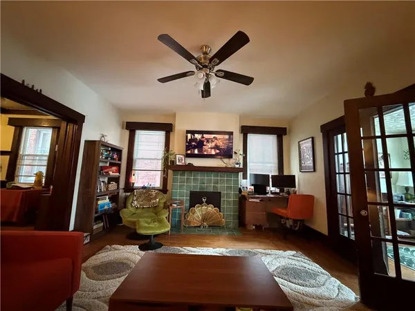 a living room with furniture a window and a flat screen tv
