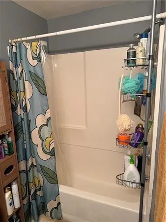 a bathroom with a bathtub and a shower