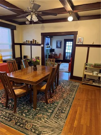 a dining room with furniture a rug and a chandelier