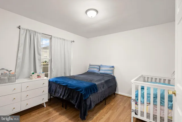 a bedroom with a bed window and a dresser