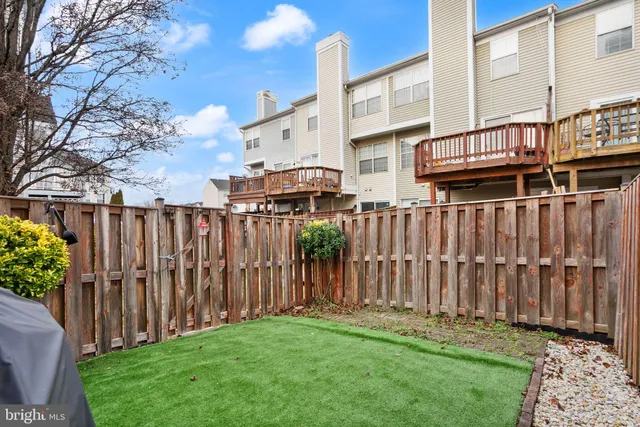 a view of a house with wooden fence