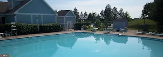 a swimming pool with outdoor seating and yard