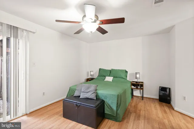 a bedroom with furniture and a wooden floor