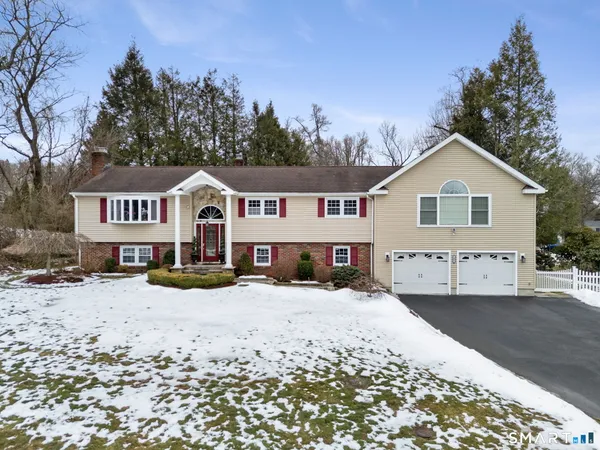 a view of a house with a yard covered in snow