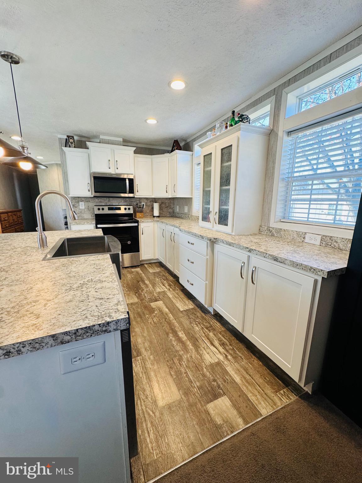 720 Mountain Road Pine Grove, PA 17963 - Photo 34 of 35 a kitchen with stainless steel appliances granite countertop a sink stove and microwave