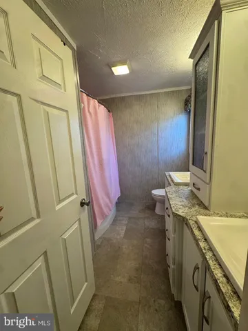 a bathroom with a sink a mirror and a shower