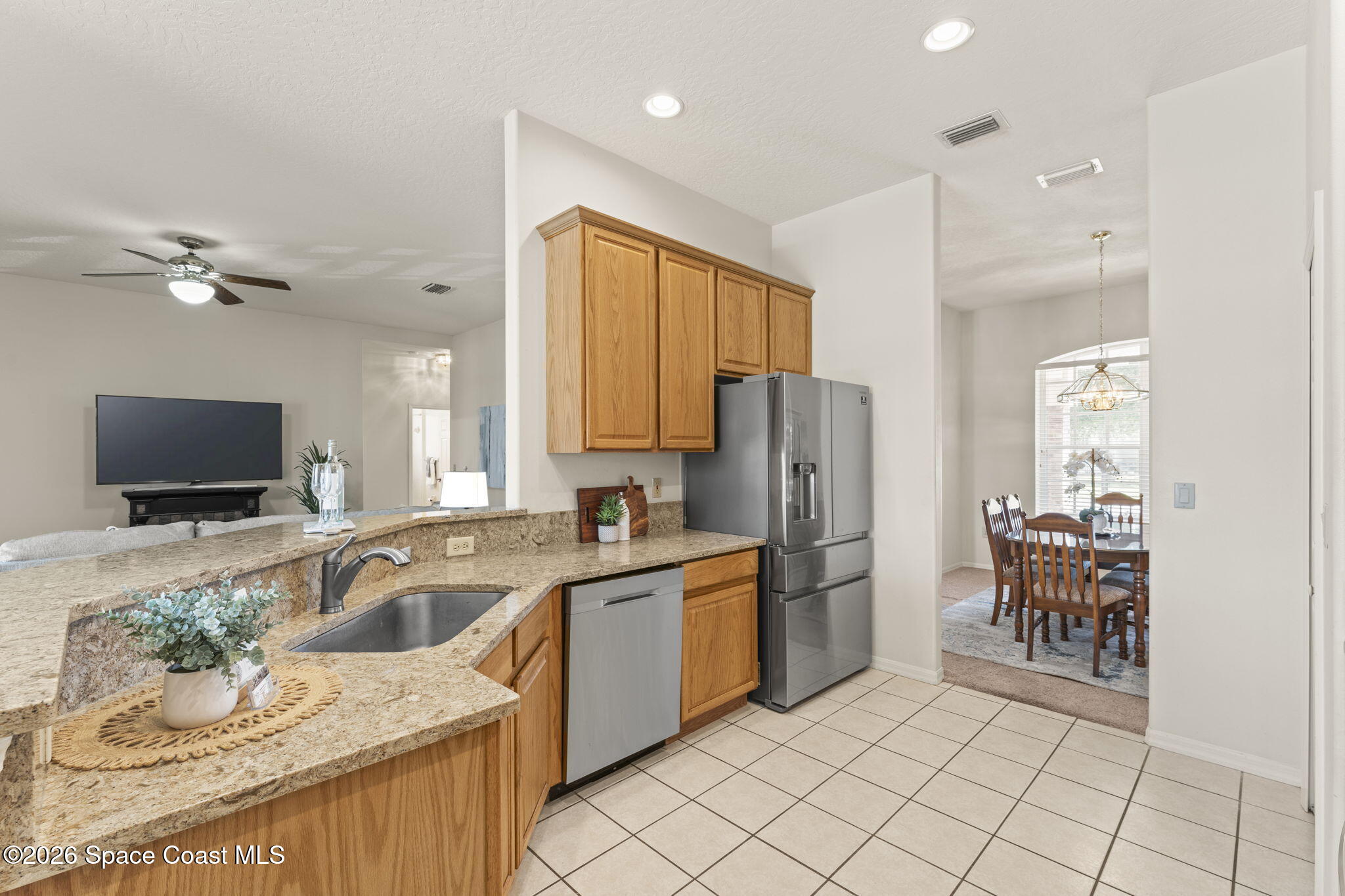 1123 Spring Oak Drive Melbourne, FL 32901 - Photo 20 of 67 a kitchen with a sink a counter top space appliances and cabinets