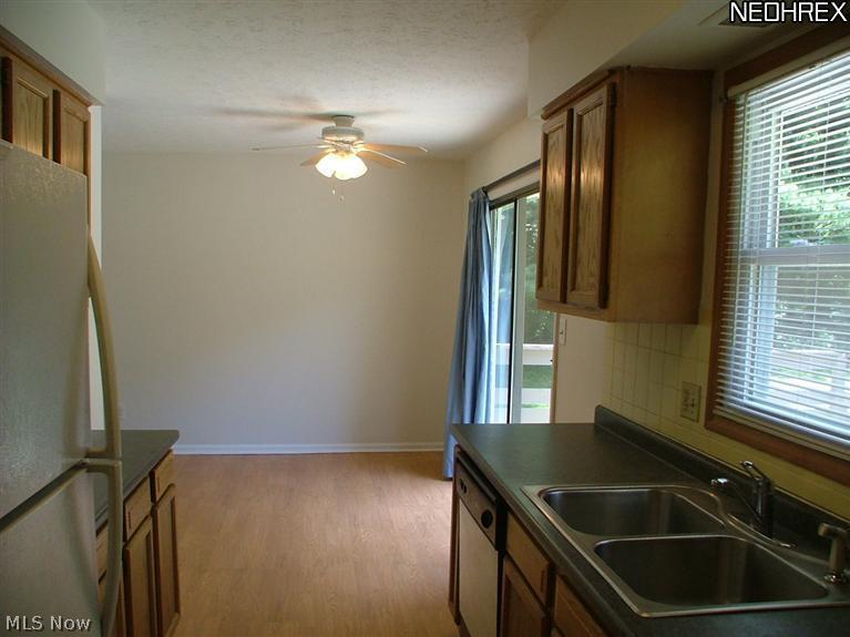 3194 Shellhart Road Norton, OH 44203 - Photo 5 of 18 The wood floor kitchen offers views of the back yard and leads into the dinette.