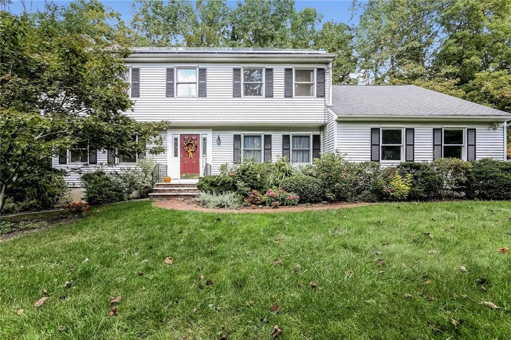119 Chambers Road Danbury, CT 06811 - Photo 1 of 1 a front view of a house with a yard and trees