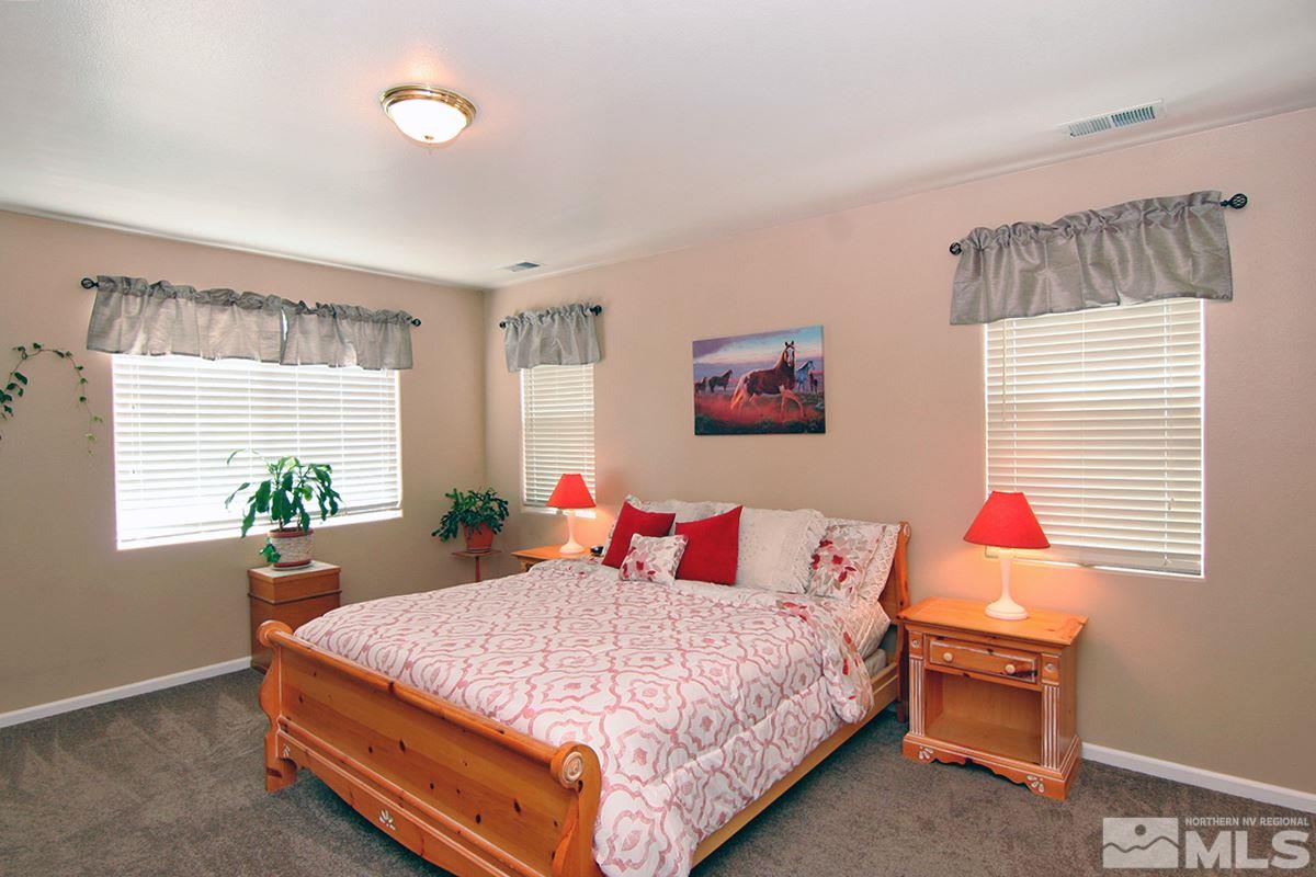 10860 Rushing Flume Drive Reno, NV 89521 - Photo 11 of 23 a bedroom with a bed and a dresser next to a window