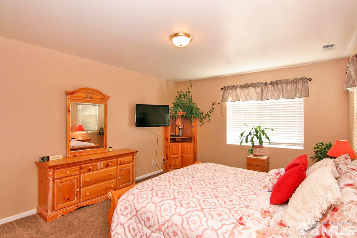 10860 Rushing Flume Drive Reno, NV 89521 - Photo 12 of 23 a bedroom with a bed and a flat screen tv