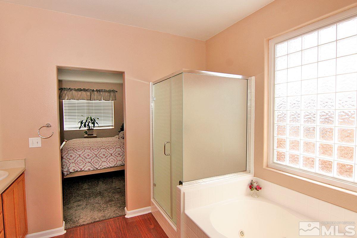 10860 Rushing Flume Drive Reno, NV 89521 - Photo 13 of 23 a en suite bathroom with a tub and a window