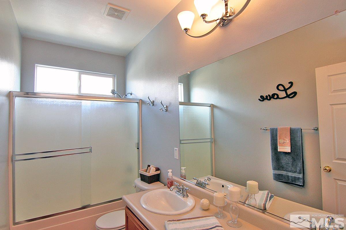 10860 Rushing Flume Drive Reno, NV 89521 - Photo 17 of 23 a bathroom with a sink toilet and shower