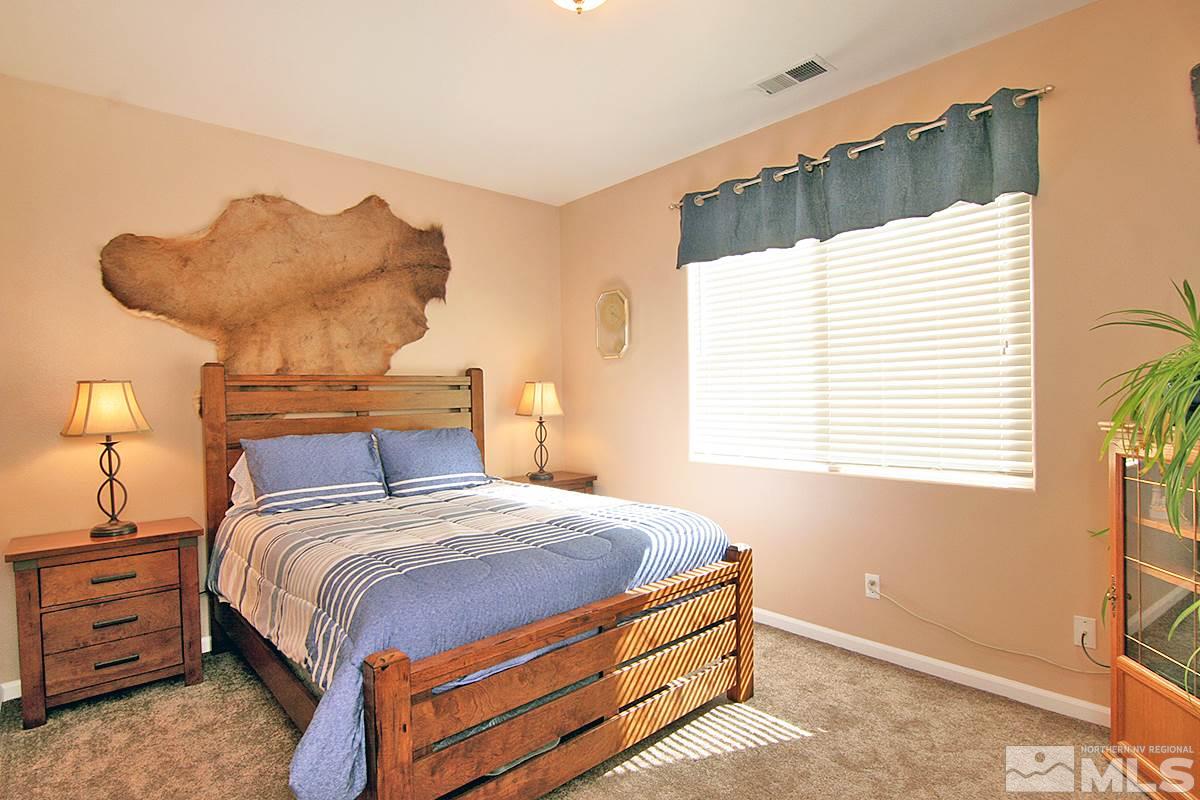 10860 Rushing Flume Drive Reno, NV 89521 - Photo 18 of 23 a bedroom with a bed and a window