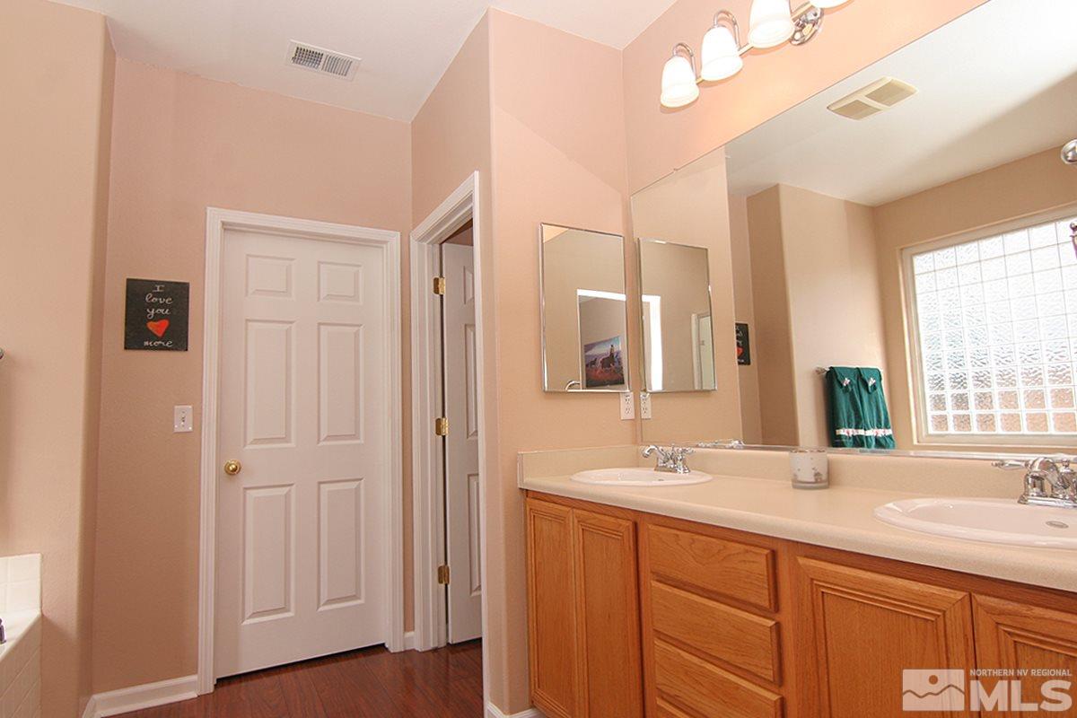 10860 Rushing Flume Drive Reno, NV 89521 - Photo 19 of 23 a bathroom with a double vanity sink and a mirror