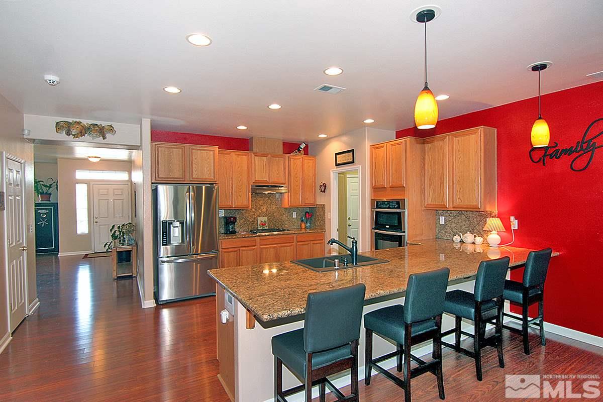 10860 Rushing Flume Drive Reno, NV 89521 - Photo 3 of 23 a view of a dining room with furniture and wooden floor