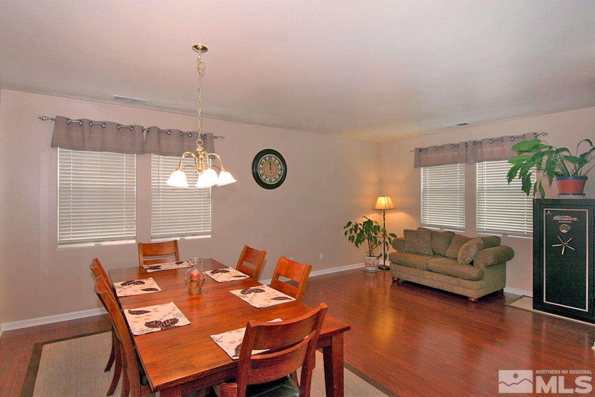 10860 Rushing Flume Drive Reno, NV 89521 - Photo 9 of 23 a view of a dining room with furniture and a potted plant