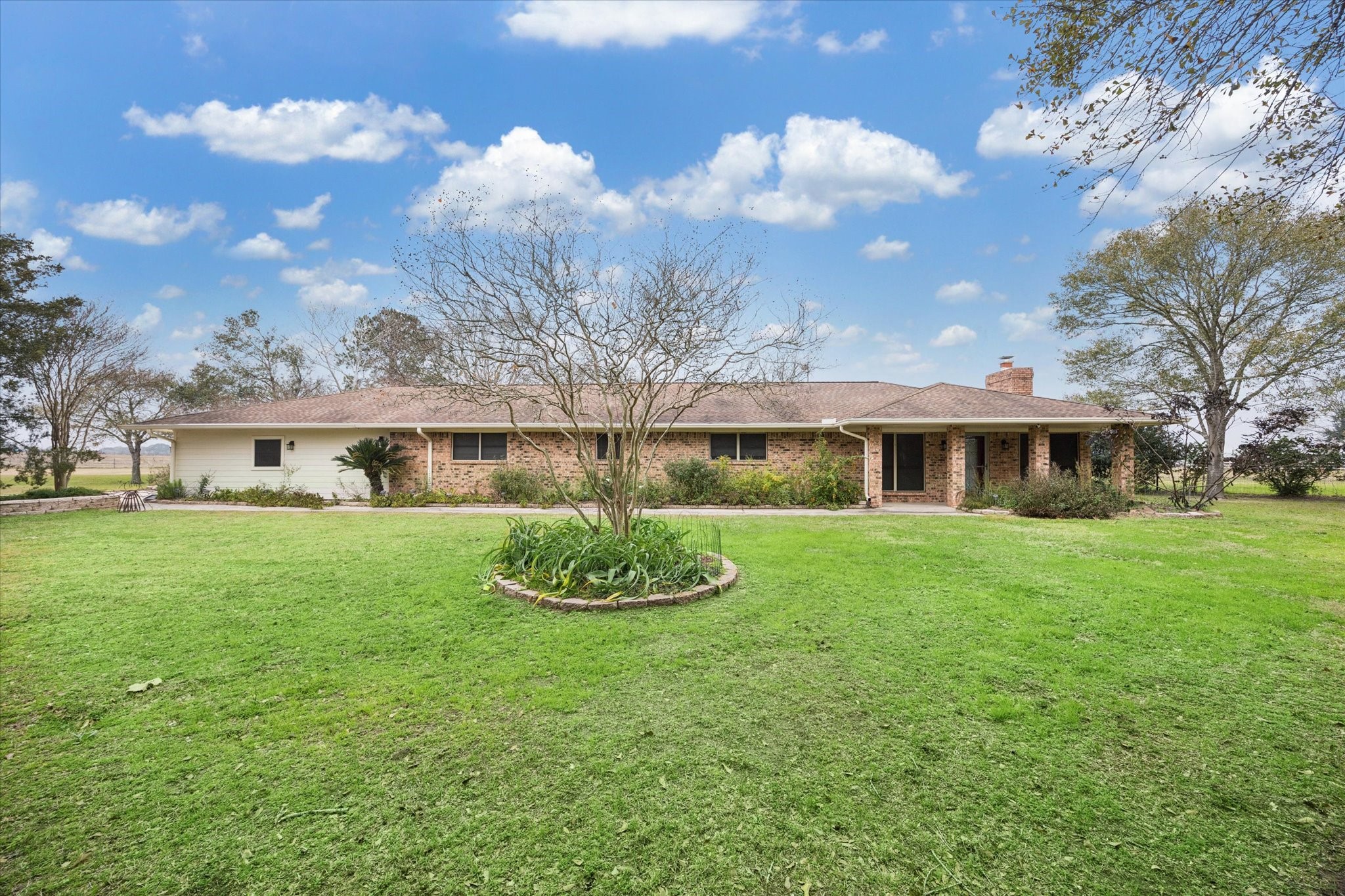 a front view of a house with a garden and plants