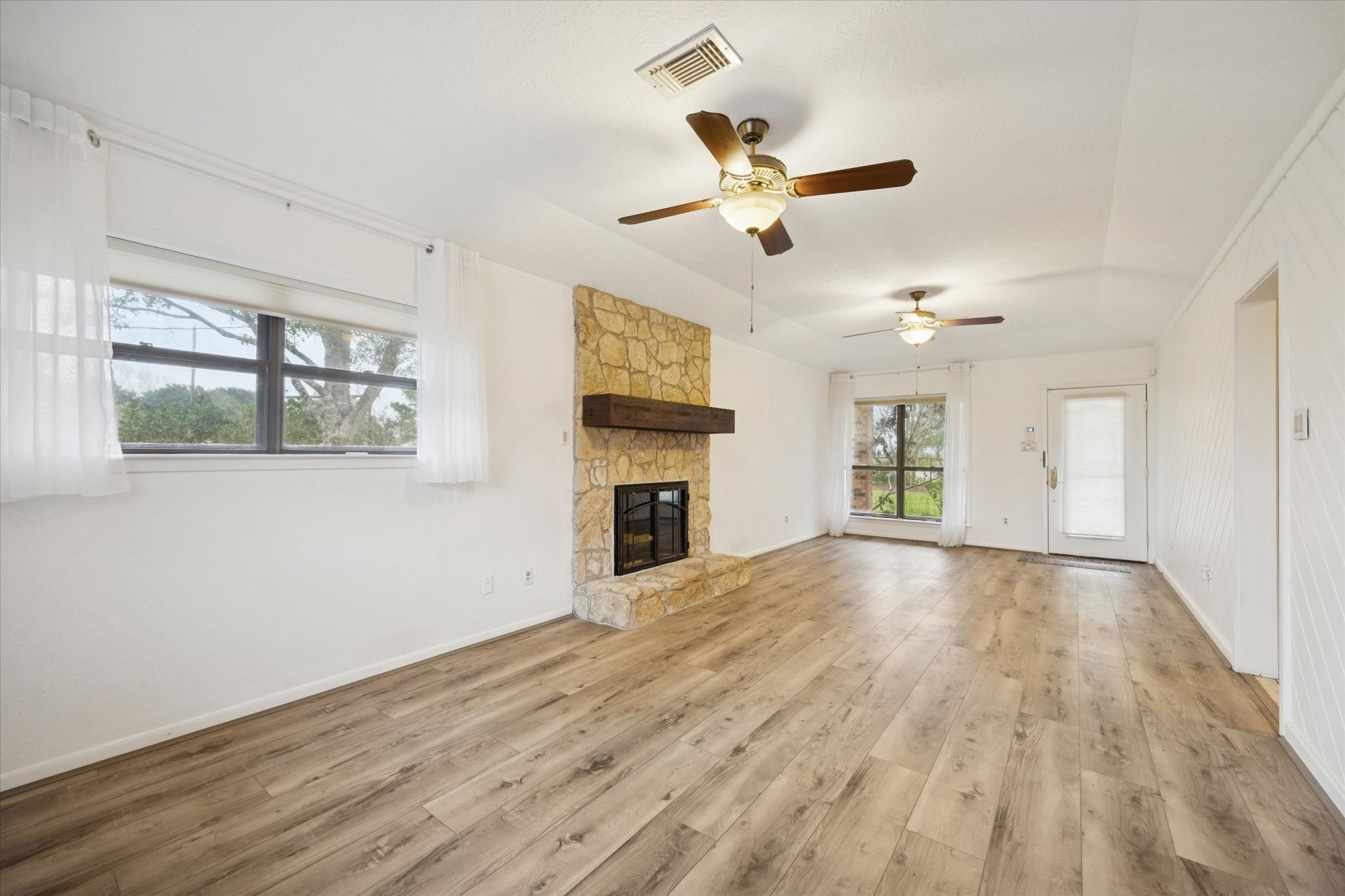 479 South Farm To Market 331 Road Sealy, TX 77474 - Photo 4 of 25 a view of empty room with wooden floor and fan