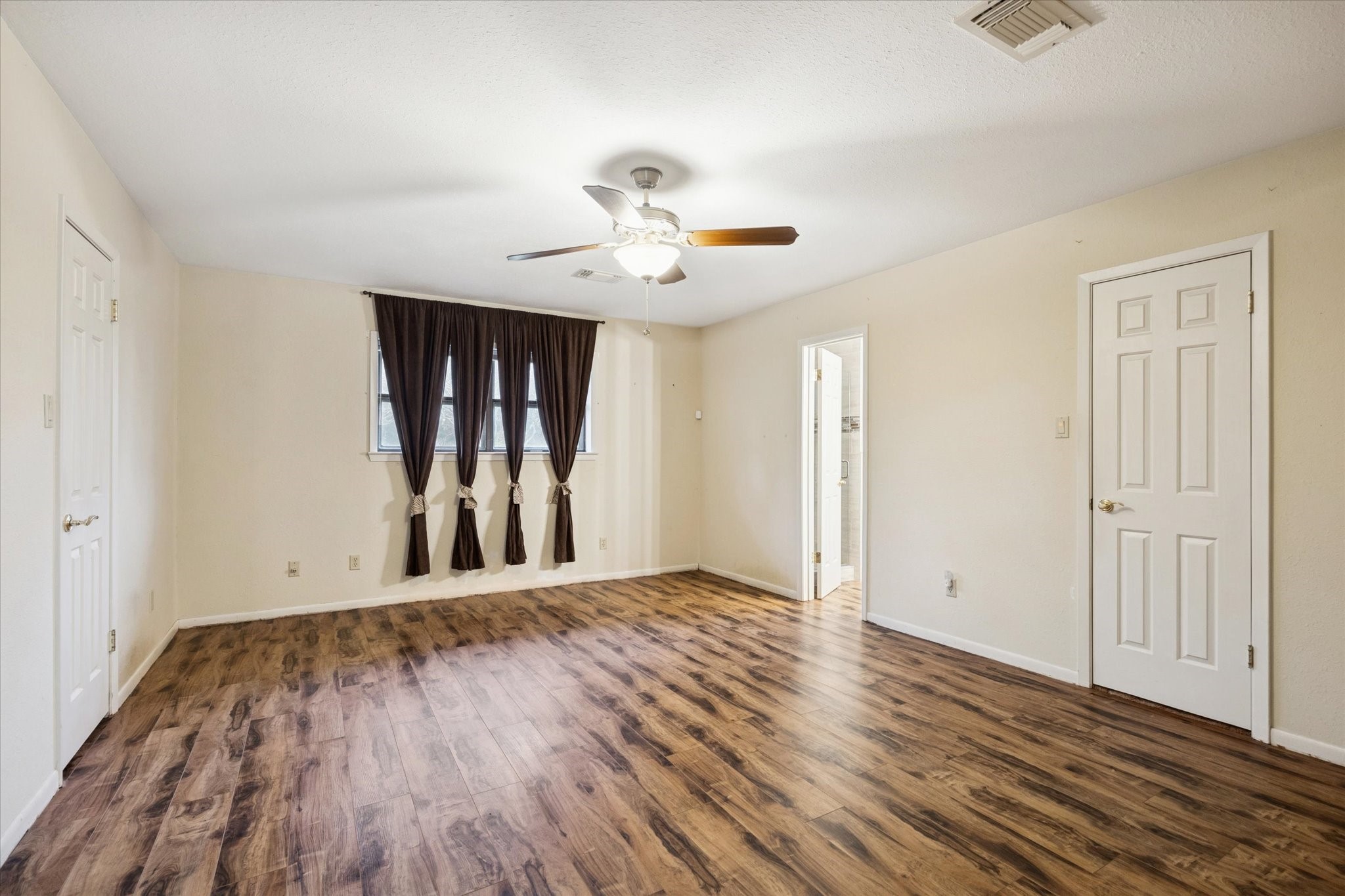 479 South Farm To Market 331 Road Sealy, TX 77474 - Photo 10 of 25 an empty room with wooden floor and ceiling fan