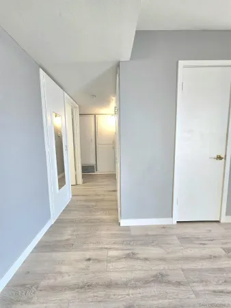a view of a hallway with wooden floor