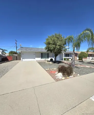 a house with palm tree in front of it