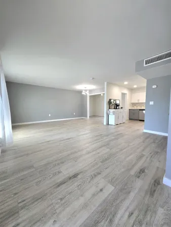 a view of a room with wooden floor