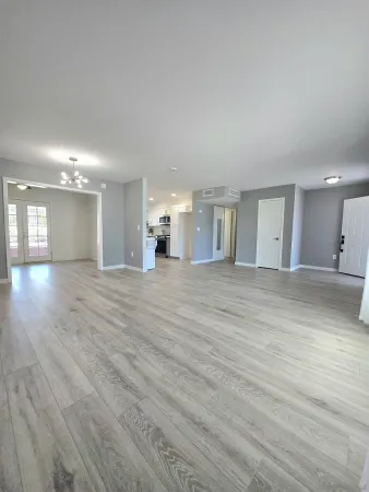 a view of a hallway with wooden floor