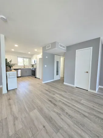 a view of a livingroom with a furniture wooden floor and a window