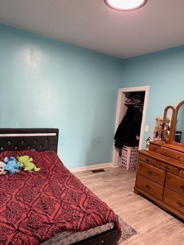 10 Byron Street Worcester, MA 01605 - Photo 11 of 33 a bedroom with a bed and a lamp on dresser