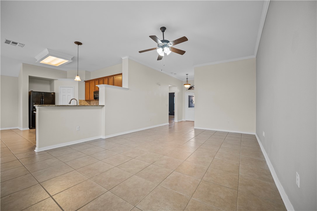 7509 Exeter Corpus Christi, TX 78414 - Photo 12 of 29 a view of a kitchen with a sink and a refrigerator a ceiling fan