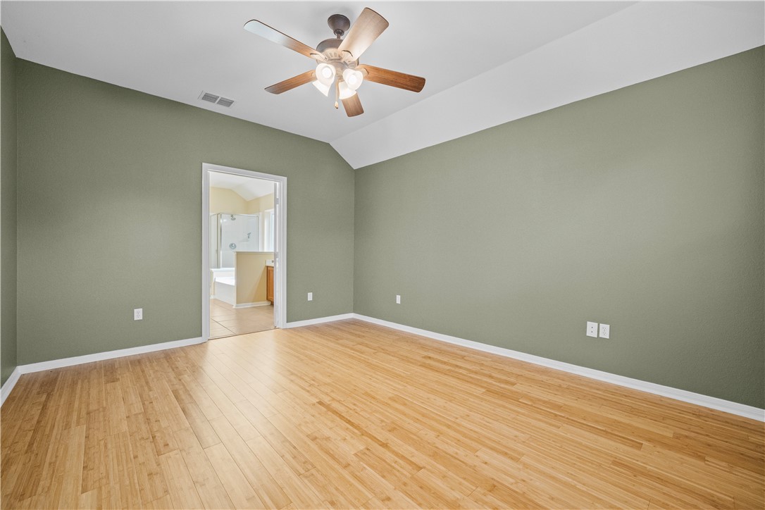 7509 Exeter Corpus Christi, TX 78414 - Photo 15 of 29 wooden floor in an empty room with a chandelier fan