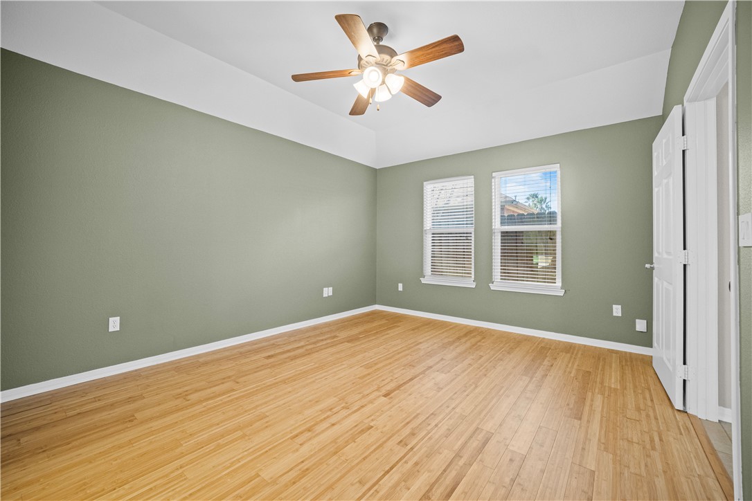 7509 Exeter Corpus Christi, TX 78414 - Photo 16 of 29 wooden floor in an empty room with a window