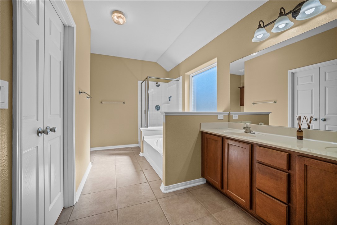 7509 Exeter Corpus Christi, TX 78414 - Photo 17 of 29 a bathroom with a sink a mirror and a vanity