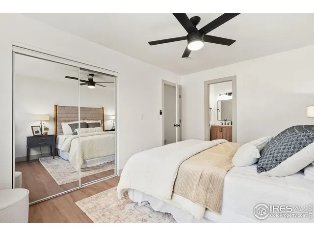 a bedroom with a bed and a large mirror