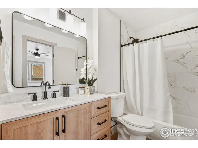 a bathroom with a double vanity sink mirror and toilet