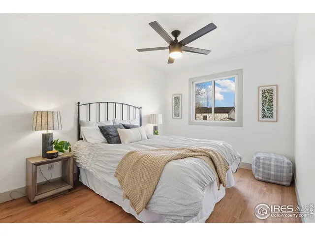 a bedroom with a bed a couch and a chandelier