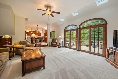 a living room with furniture fireplace and a large window