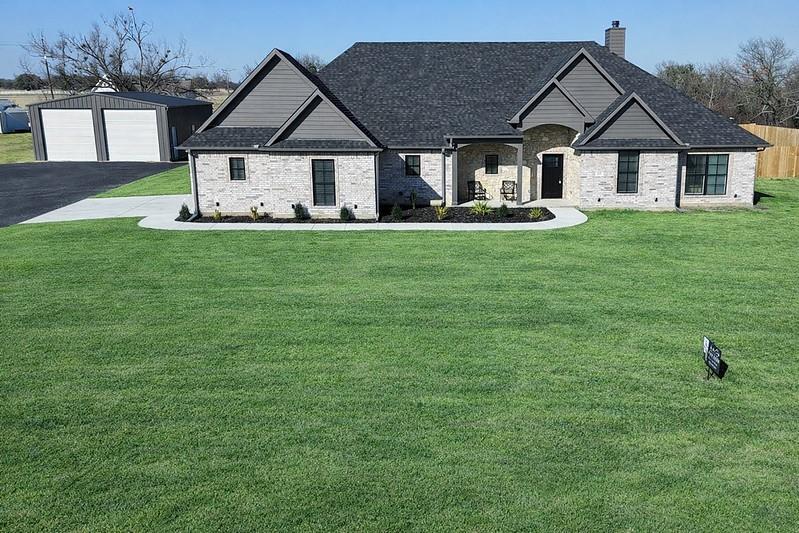 a front view of a house with a yard