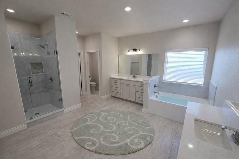 25 Pear Tree Lane Collinsville, TX 76233 - Photo 14 of 34 a view of a bathroom with a tub shower and mirror