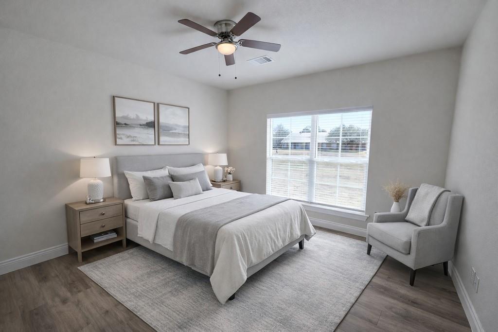 25 Pear Tree Lane Collinsville, TX 76233 - Photo 19 of 34 a spacious bedroom with a bed and a couch