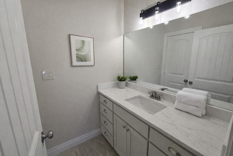 25 Pear Tree Lane Collinsville, TX 76233 - Photo 22 of 34 a bathroom with 2 sink and a mirror