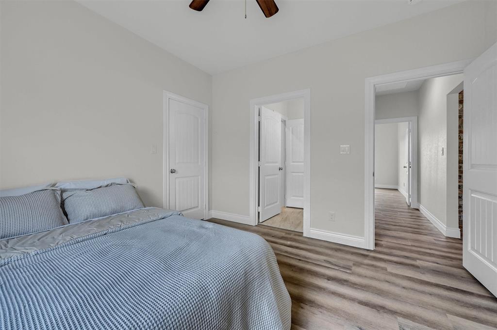 25 Pear Tree Lane Collinsville, TX 76233 - Photo 24 of 34 a bedroom with a bed and wooden floor