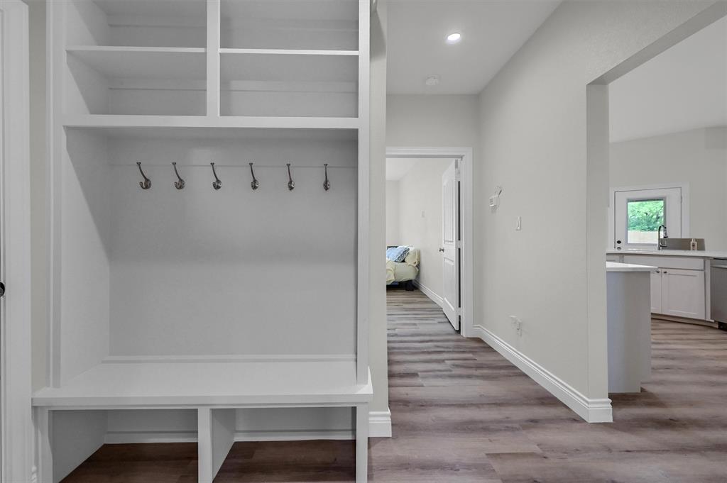 25 Pear Tree Lane Collinsville, TX 76233 - Photo 28 of 34 a view of a hallway with wooden floor and cabinet