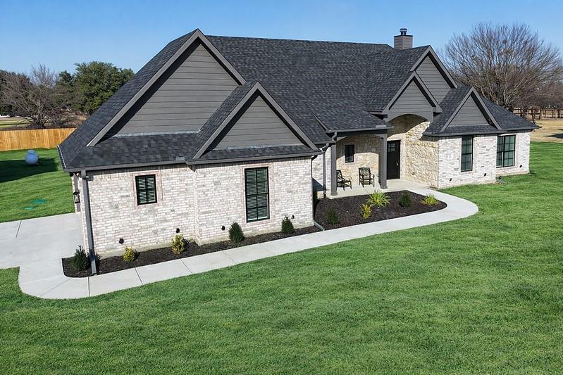 25 Pear Tree Lane Collinsville, TX 76233 - Photo 4 of 34 a front view of a house with a yard