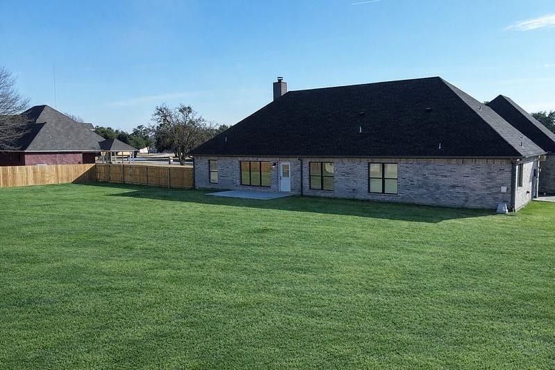 25 Pear Tree Lane Collinsville, TX 76233 - Photo 5 of 34 a front view of a house with a garden
