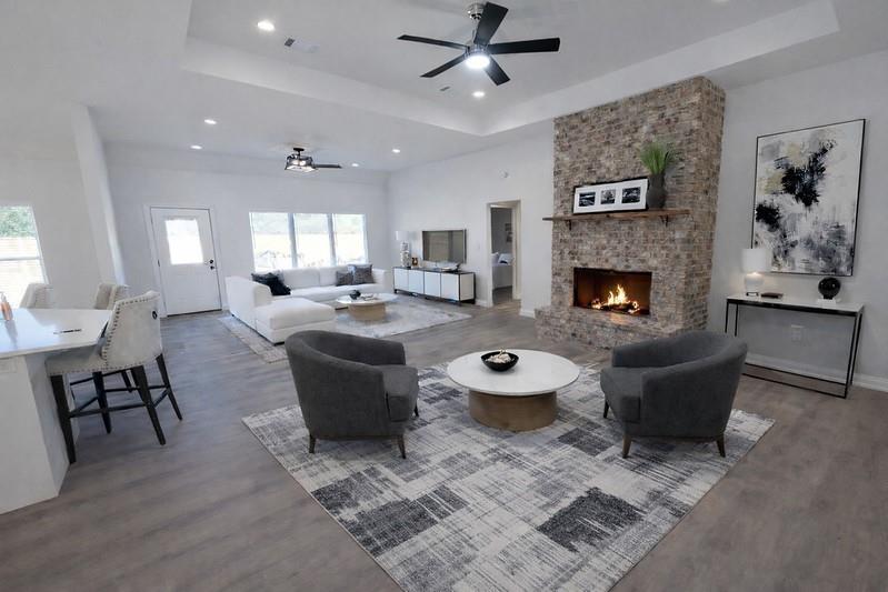 25 Pear Tree Lane Collinsville, TX 76233 - Photo 7 of 34 a living room with furniture and a fireplace